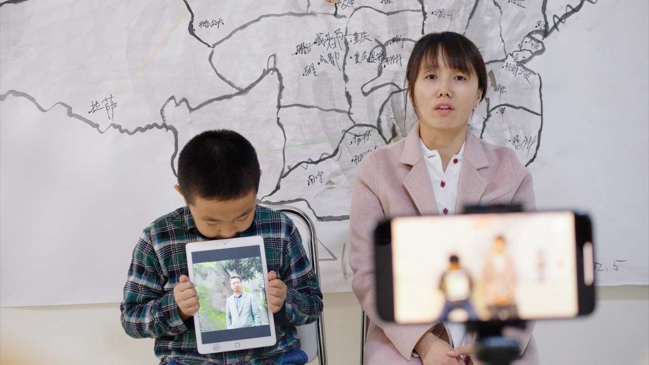 a woman and child being filmed on a phone